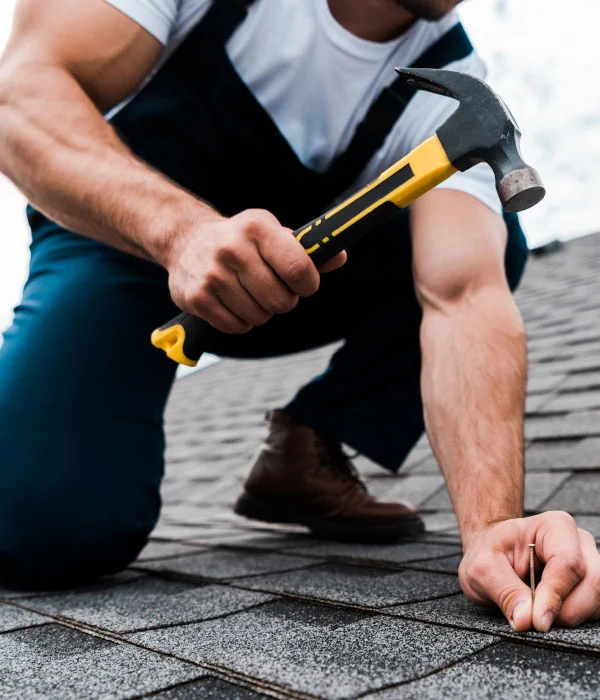 Cropped View Of Handyman In Uniform Holding Hammer FM77ZCC